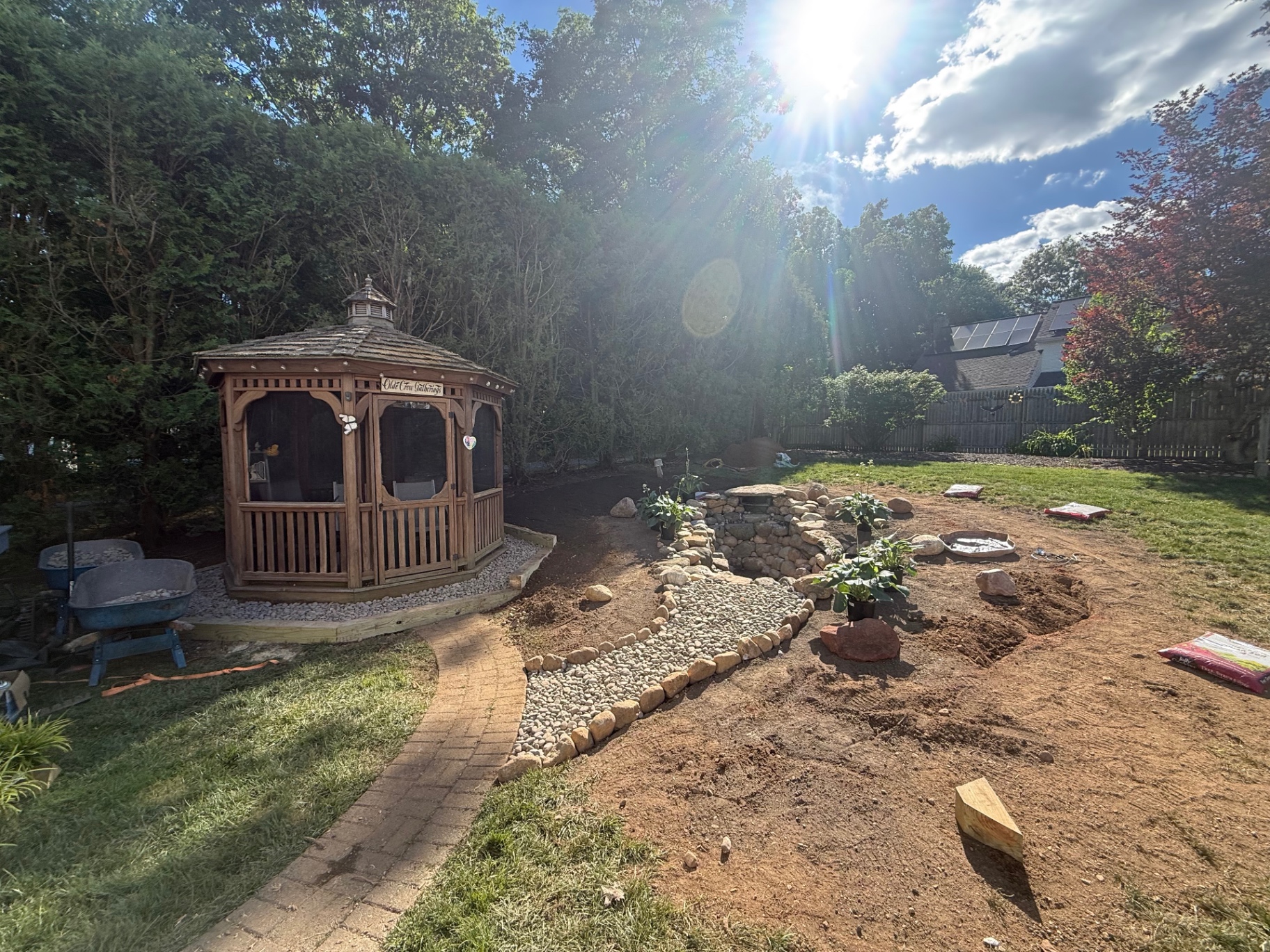 Wide view of backyard pond, dry creek bed, and existing gazebo integration in Naugatuck, CT