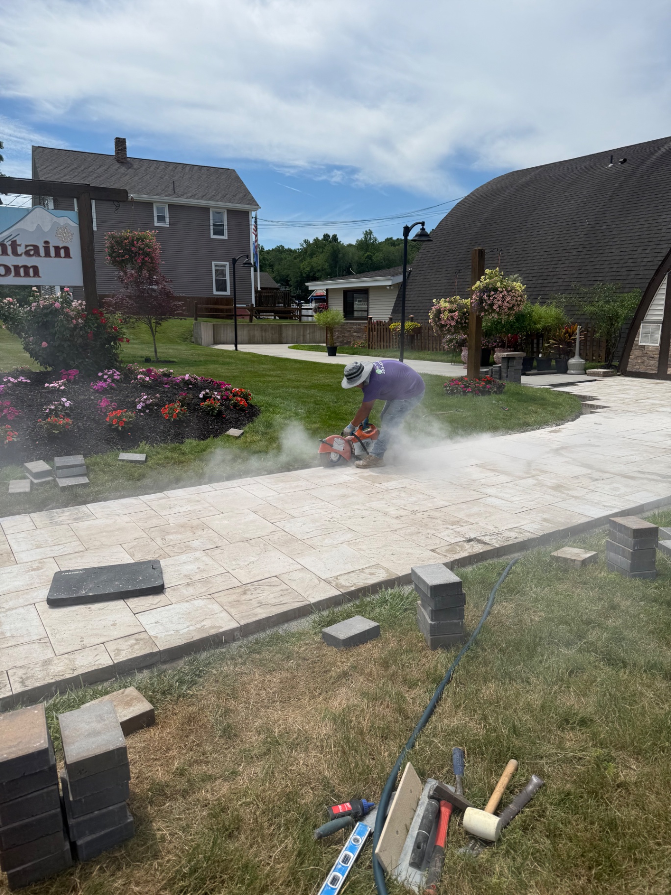 Patio crew making precision paver cuts on site at Mount Southington, CT